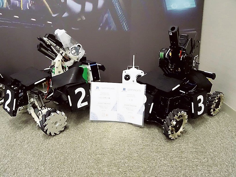 19年度サマーキャンプで第3位とベストデザイン賞を受賞した、OSAKA TAKOYAKIの歩兵ロボット（自作機〈左〉と主催者提供機）