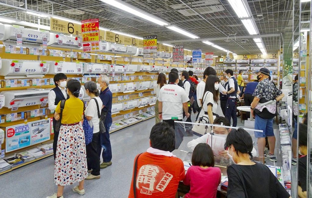 エアコンの商品説明に熱心に耳を傾ける来店者（ヤマダ電機LABI1日本総本店池袋） 