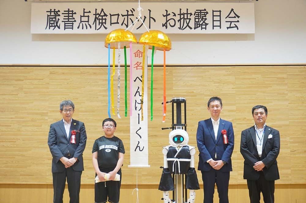 平泉町学習交流施設 エピカで開催した、ＫｏＫｏＢｏシステム搭載ＤＸ業務ロボット１号機「べんけーくん」のお披露目式の様子（写真左は菅原幹成・平泉町副町長、左から二番目は、愛称投票者代表の高橋理央さん）