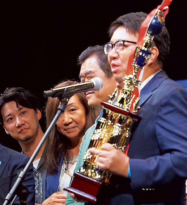 優勝トロフィーを手に喜びを語る竹下社長（右）